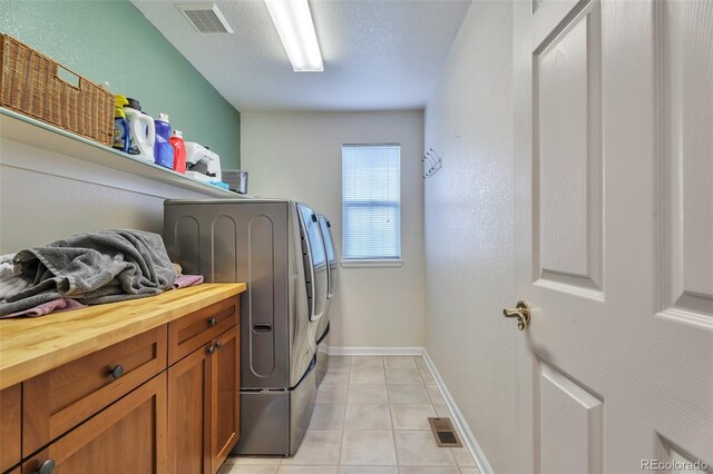 10695 Wynspire Rd, Highlands Ranch, CO 80130 - laundry area featuring washer and clothes dryer, light tile patterned floors, and baseboards
