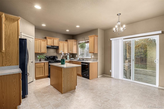 kitchen with black appliances, a chandelier, sink, a kitchen island, and pendant lighting