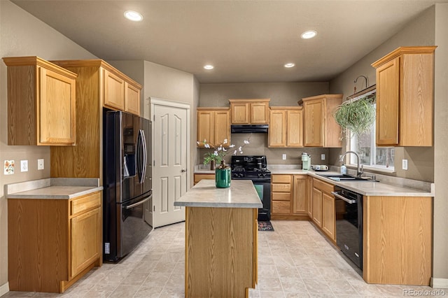 kitchen featuring light brown cabinetry, black appliances, sink, and a kitchen island