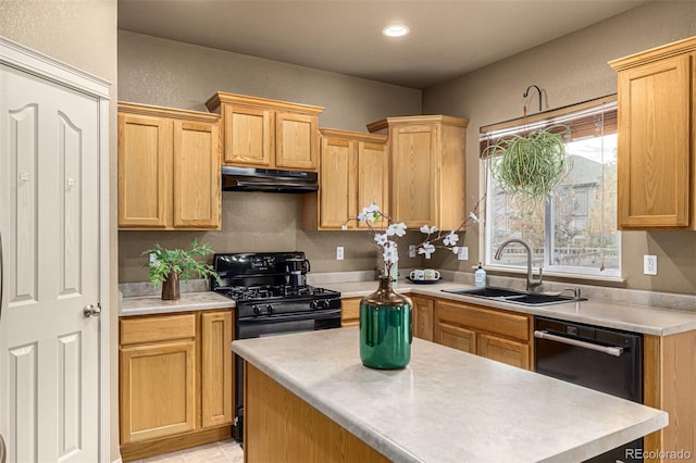 kitchen with black appliances, light brown cabinetry, sink, and a center island