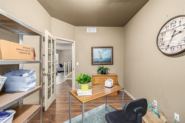 office space featuring dark wood-type flooring, french doors, and a textured ceiling