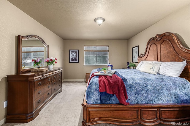 carpeted bedroom with a textured ceiling and multiple windows