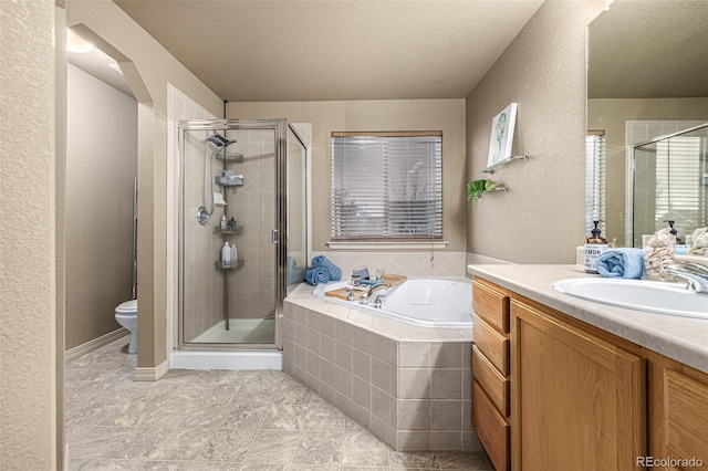 full bathroom featuring tile patterned floors, toilet, a textured ceiling, plus walk in shower, and vanity