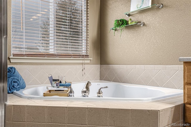 bathroom featuring tiled bath and vanity