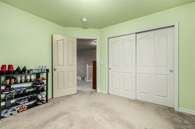 carpeted bedroom with a closet