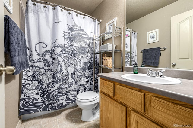 bathroom featuring vanity, tile patterned flooring, toilet, and a textured ceiling