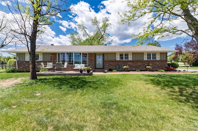 10220 W Montgomery Ave, Littleton, CO 80127 - ranch-style home featuring brick siding, board and batten siding, and a front lawn