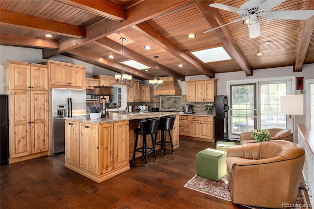 10220 W Montgomery Ave, Littleton, CO 80127 - kitchen featuring premium range hood, stainless steel appliances, light brown cabinetry, dark wood-style floors, and a chandelier