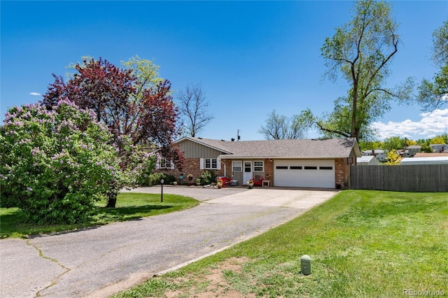 10220 W Montgomery Ave, Littleton, CO 80127 - single story home with a garage, brick siding, and concrete driveway