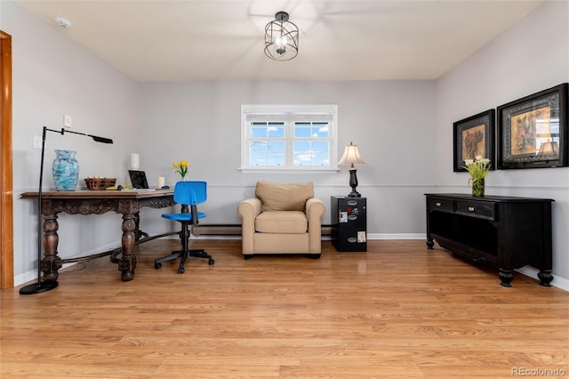 10220 W Montgomery Ave, Littleton, CO 80127 - home office featuring light wood-style floors, baseboards, and a baseboard heating unit