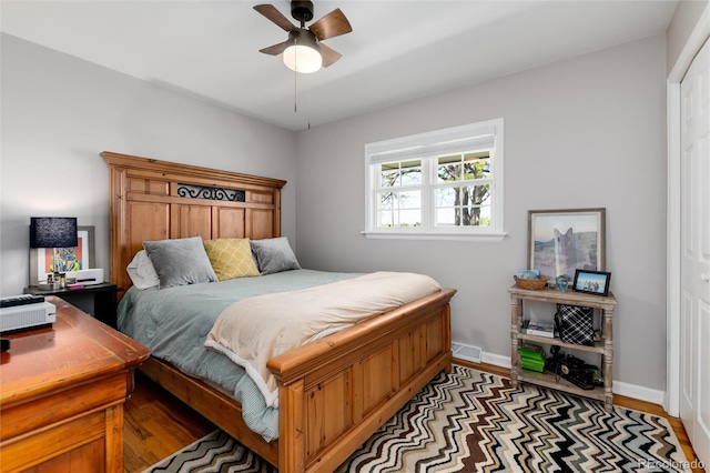 10220 W Montgomery Ave, Littleton, CO 80127 - bedroom with baseboards, light wood finished floors, a ceiling fan, and a closet