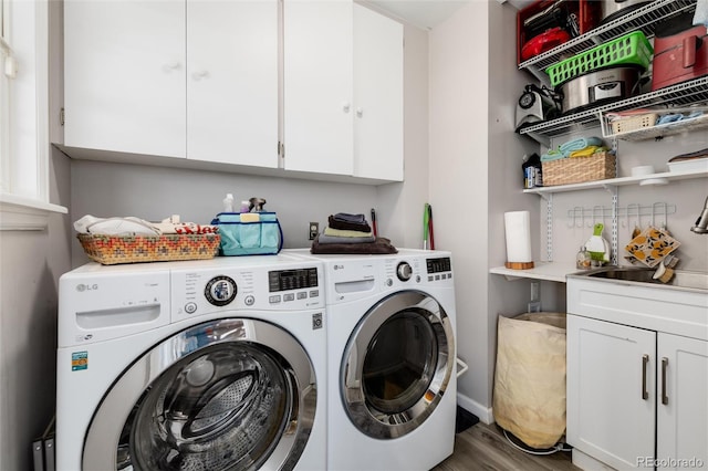 10220 W Montgomery Ave, Littleton, CO 80127 - laundry room with washing machine and dryer, cabinet space, wood finished floors, and baseboards