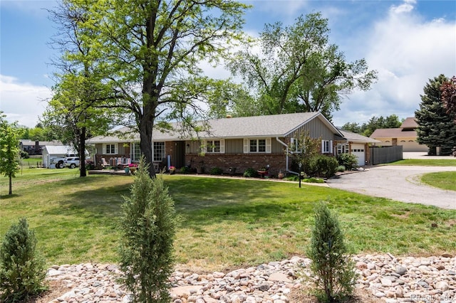 10220 W Montgomery Ave, Littleton, CO 80127 - ranch-style home featuring a garage, a front yard, driveway, and brick siding
