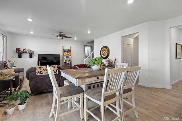 dining area featuring ceiling fan and light hardwood / wood-style flooring