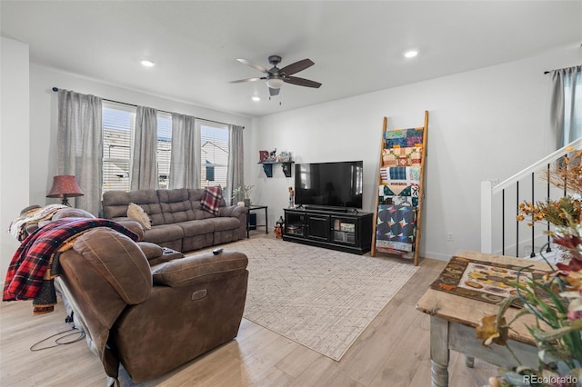 living room featuring ceiling fan and light wood-type flooring