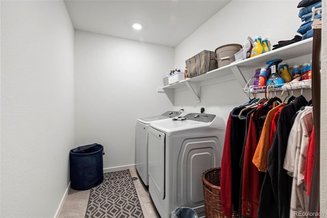 laundry room featuring independent washer and dryer and light tile patterned flooring