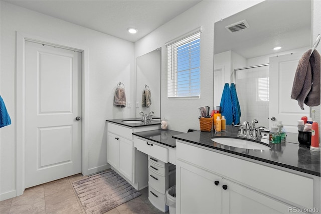 bathroom featuring vanity, tile patterned floors, and a shower with door