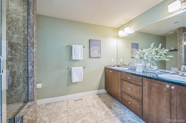 2539 N York St, Denver, CO 80205 - bathroom with double vanity, tile patterned flooring, baseboards, and a tile shower