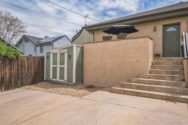 2539 N York St, Denver, CO 80205 - doorway to property with a patio area, stucco siding, and fence