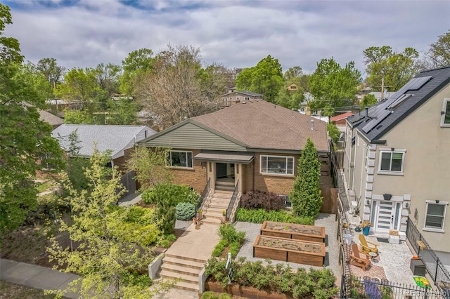 2539 N York St, Denver, CO 80205 - view of front of property featuring a vegetable garden, fence, and brick siding