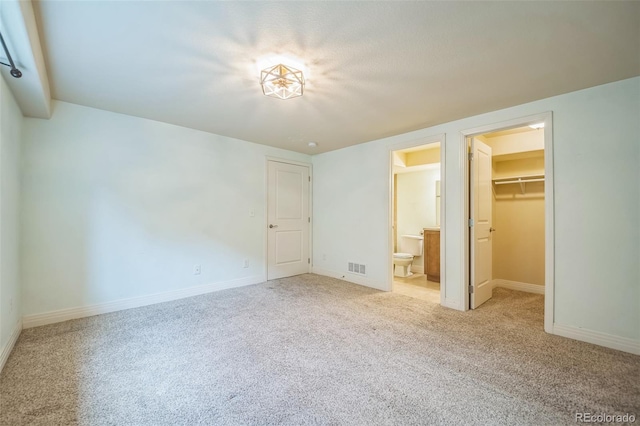 2539 N York St, Denver, CO 80205 - unfurnished bedroom featuring carpet flooring, a spacious closet, a closet, and baseboards