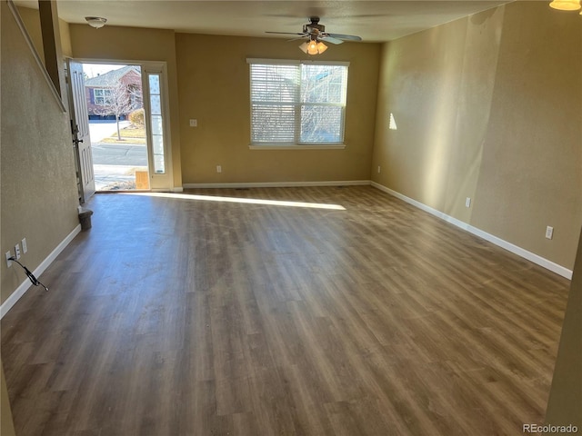 unfurnished room featuring dark wood-type flooring and ceiling fan