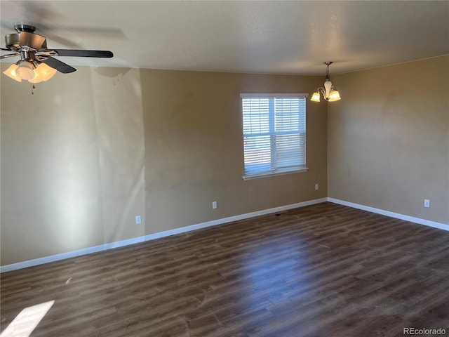 unfurnished room featuring baseboards, dark wood-type flooring, and ceiling fan with notable chandelier