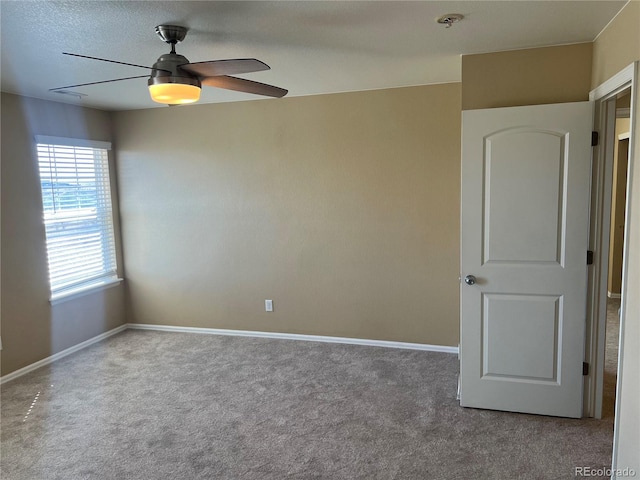 unfurnished room with baseboards, carpet floors, and ceiling fan