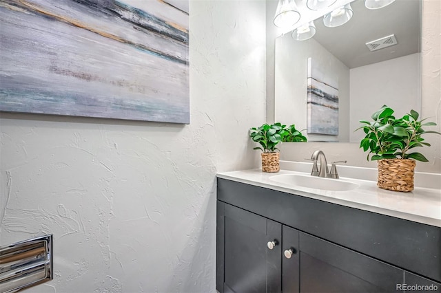 1470 S Quebec Way Unit 62, Denver, CO 80231 - bathroom featuring vanity and a textured wall