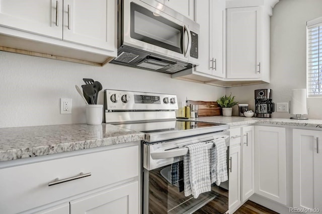 kitchen with white cabinetry and appliances with stainless steel finishes