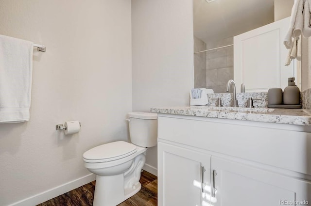 bathroom featuring hardwood / wood-style flooring, vanity, and toilet