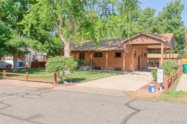 3230 Balsam St, Wheat Ridge, CO 80033 - ranch-style home with driveway, brick siding, and a carport