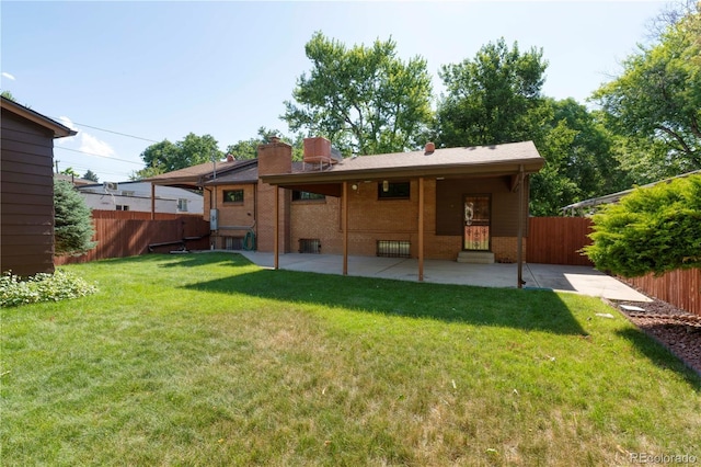3230 Balsam St, Wheat Ridge, CO 80033 - rear view of house featuring a patio area, brick siding, and a chimney