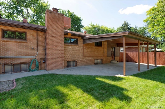 3230 Balsam St, Wheat Ridge, CO 80033 - back of house with brick siding, a chimney, and a patio area