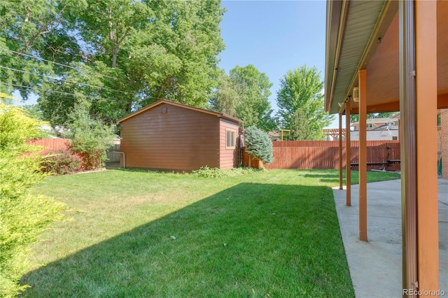 3230 Balsam St, Wheat Ridge, CO 80033 - fenced backyard with a patio and an outbuilding
