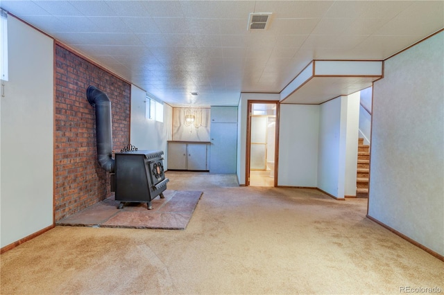 3230 Balsam St, Wheat Ridge, CO 80033 - unfurnished living room featuring carpet, stairs, and a wood stove