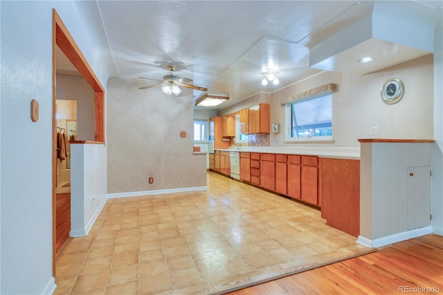 3230 Balsam St, Wheat Ridge, CO 80033 - kitchen with dishwasher, a ceiling fan, light countertops, and brown cabinetry