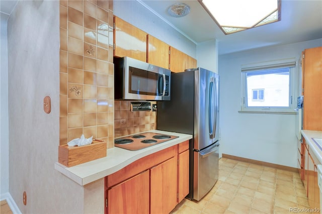 3230 Balsam St, Wheat Ridge, CO 80033 - kitchen featuring stainless steel microwave, electric cooktop, light countertops, light flooring, and backsplash