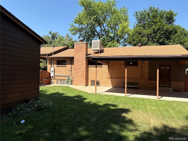 3230 Balsam St, Wheat Ridge, CO 80033 - rear view of house with brick siding, a yard, a chimney, a patio area, and roof with shingles