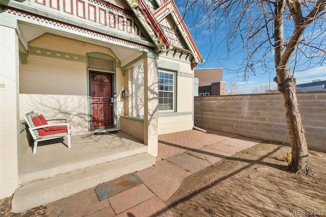 entrance to property featuring fence and a balcony