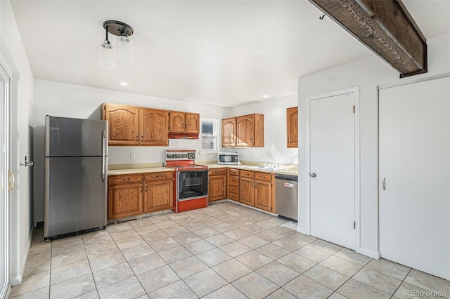 kitchen featuring light tile patterned floors, appliances with stainless steel finishes, and sink