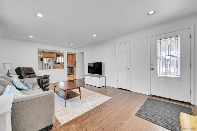 living room featuring wood-type flooring and a healthy amount of sunlight