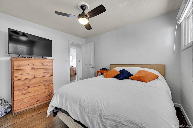 bedroom with hardwood / wood-style flooring and ceiling fan