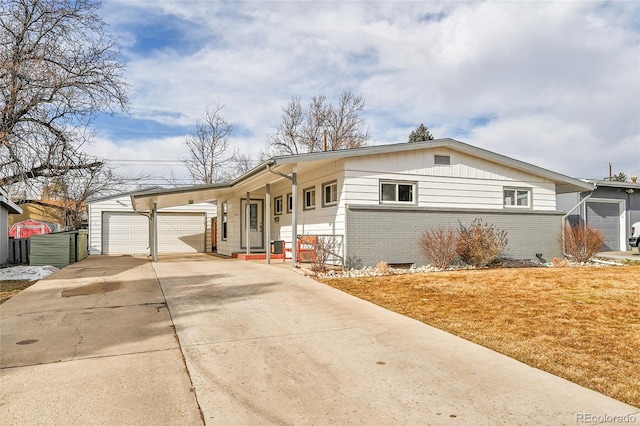 ranch-style house with a garage, a front yard, and a carport