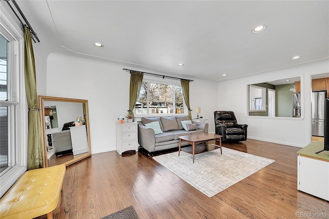 living room with baseboards, recessed lighting, and wood finished floors
