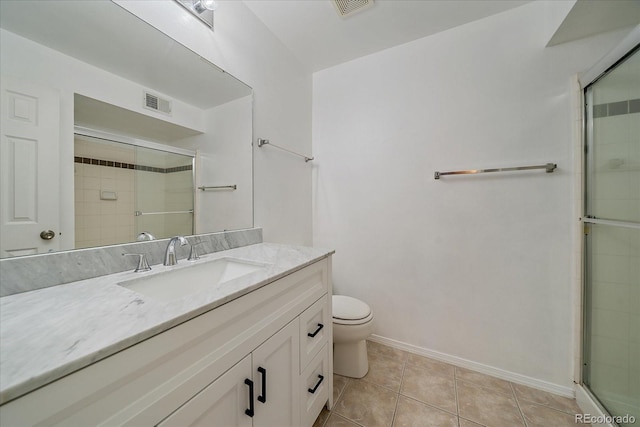 bathroom with a shower with shower door, tile patterned floors, vanity, and toilet