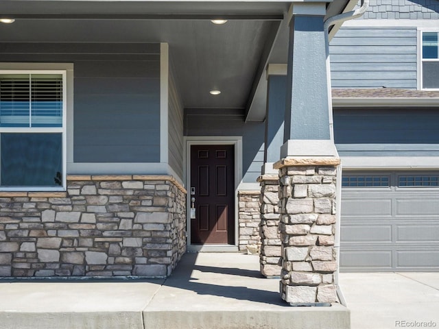 17487 E 89th Way, Commerce City, CO 80022 - doorway to property featuring stone siding and an attached garage