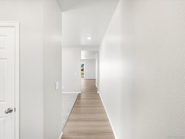 17487 E 89th Way, Commerce City, CO 80022 - hall with light wood-type flooring, baseboards, recessed lighting, and a textured wall