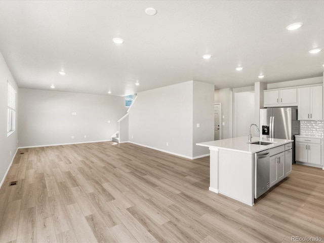 17487 E 89th Way, Commerce City, CO 80022 - kitchen featuring a sink, recessed lighting, light wood-style flooring, an island with sink, and open floor plan