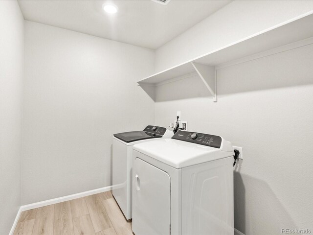 17487 E 89th Way, Commerce City, CO 80022 - laundry area featuring separate washer and dryer, light wood finished floors, and baseboards